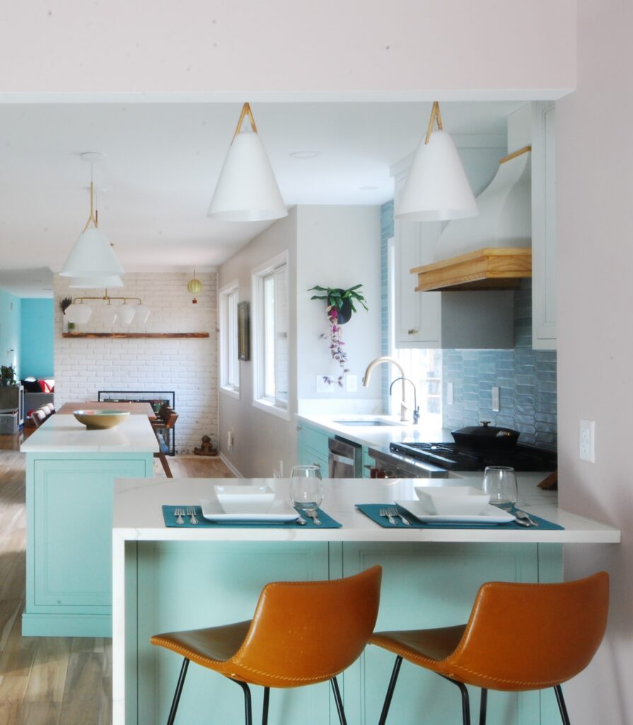 Aquamarine accented kitchen with white cabinetry for a beach-style kitchen, remodeled by Tobias Design LLC in New Jersey